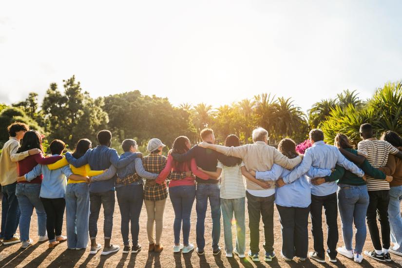 A line-up of people with their arms around each other