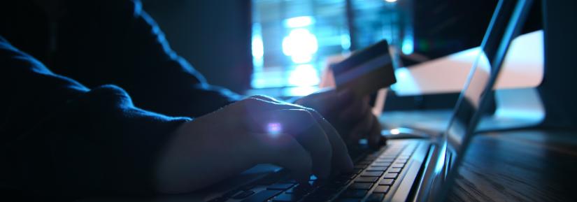 hacker at a computer in a dark room