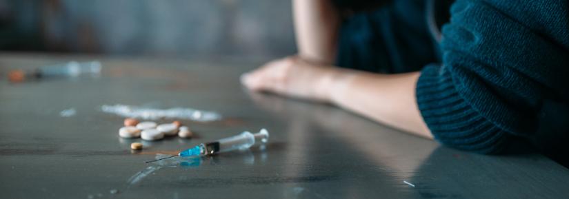 syringe on a table. Adobe Stock