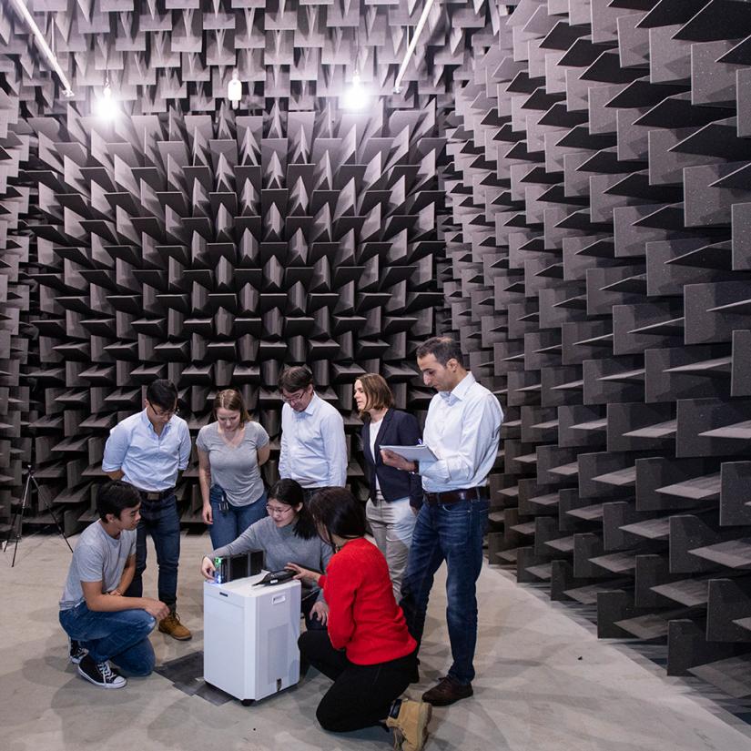 A group of people check an experiment inside the acoustic chamber at UTS Tech Lab