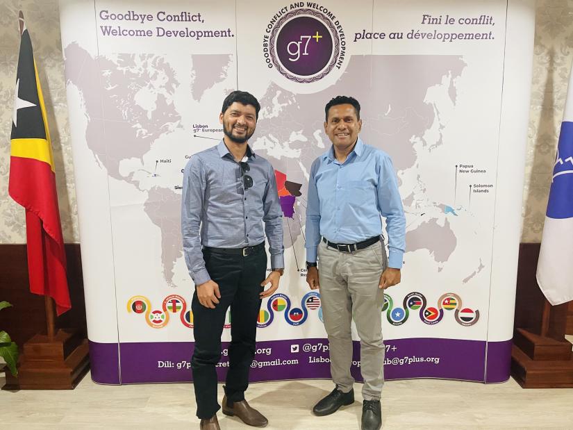 Image of Prakash Paudel with a colleague at a g7+ conference.