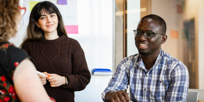 Two PhD students learning from their supervisor