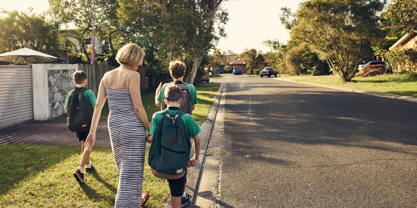 Mother walking her kids back from school