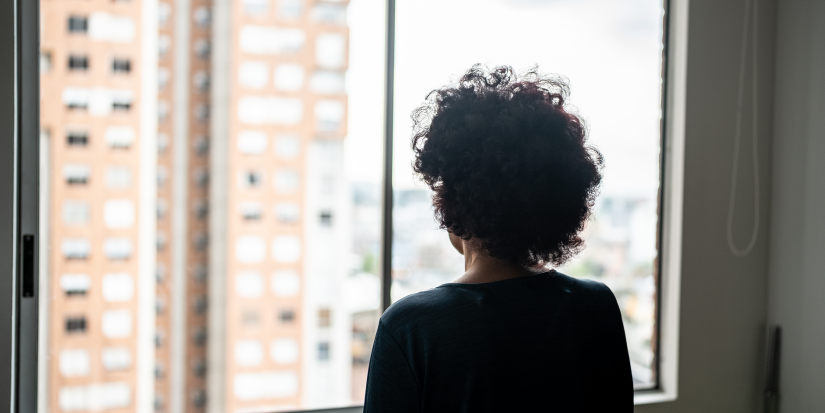 Rear view of a senior woman contemplating at home