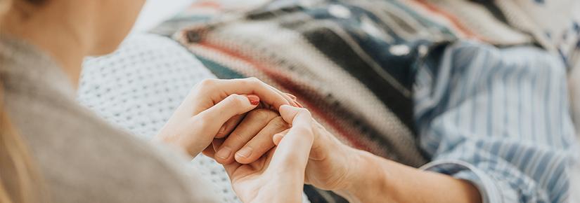 Photo of person in hospital bed receiving care