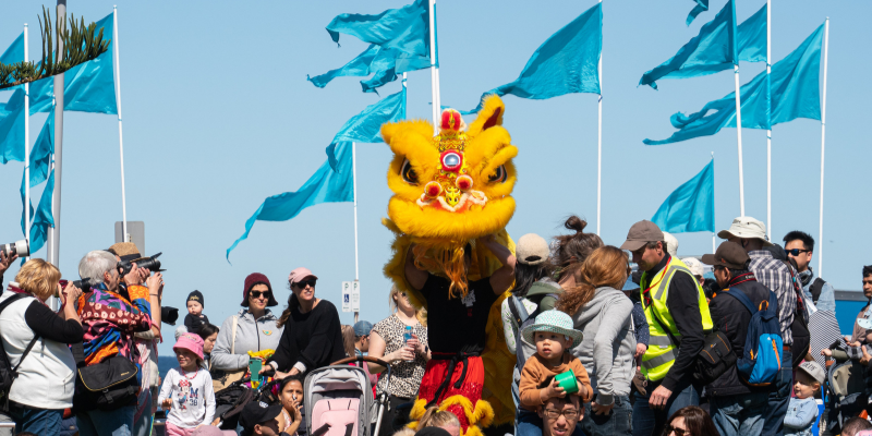 Chinese dancing lion dragon in crowd