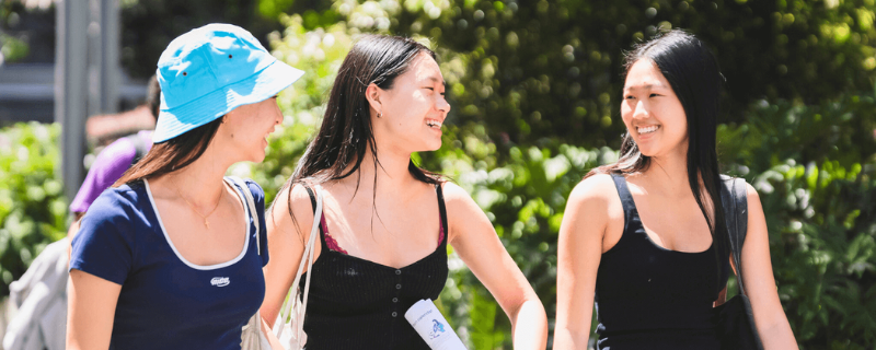 3 people walking and smiling happily