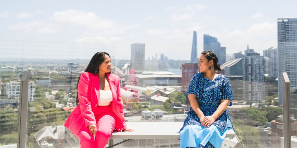 Photo of Leah Subijano and Christine Afoa in front of a city skyline