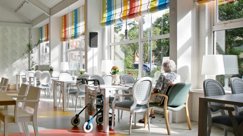 Elderly woman sitting in a sunny room