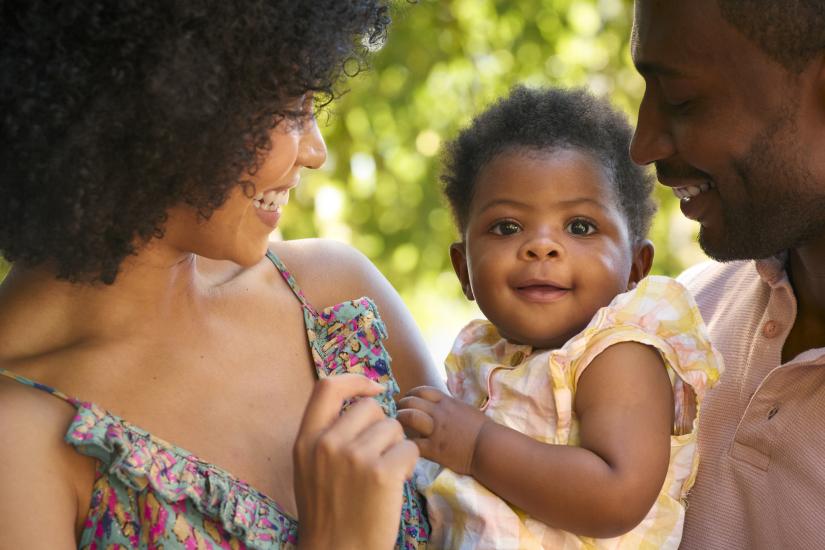 two parents look lovingly at a baby