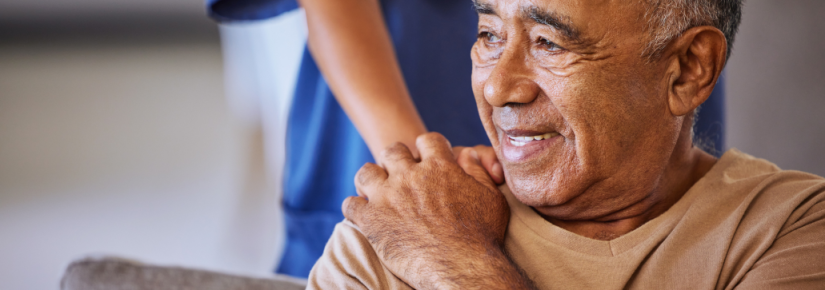 A person touches the shoulder of an old man