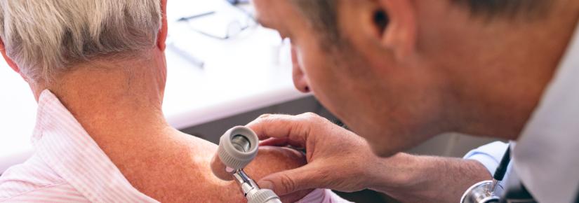 Dermatologist examining patient. Adobe Stock