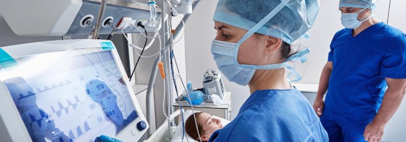 Hospital nurses checking on woman patient at intensive care unit