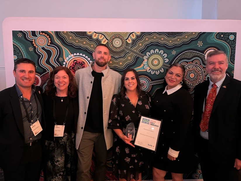 Group of people holding an award