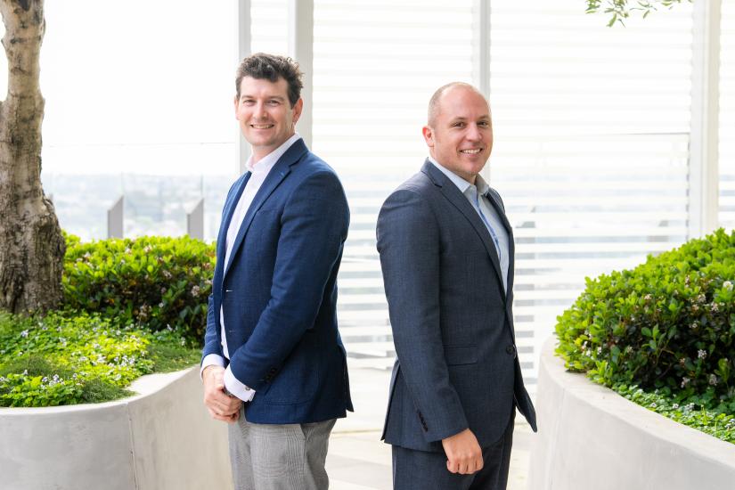 Nicholas Davis and Llewellyn Spink standing back to back