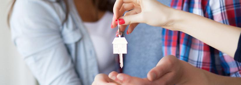 Couple with new house key. Adobe Stock image