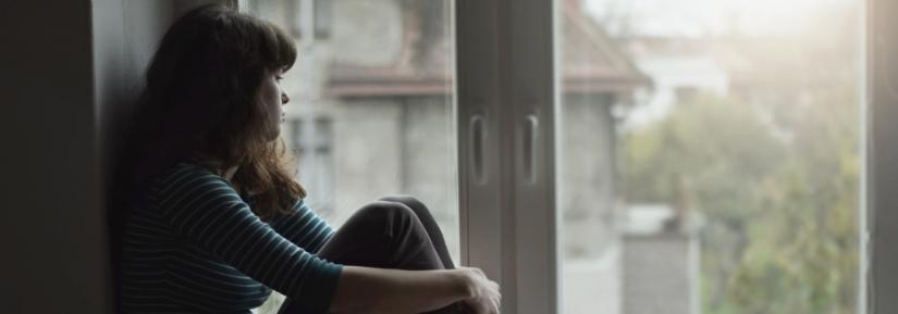 Girl by window in lockdown. Adobe Stock By Tunatura