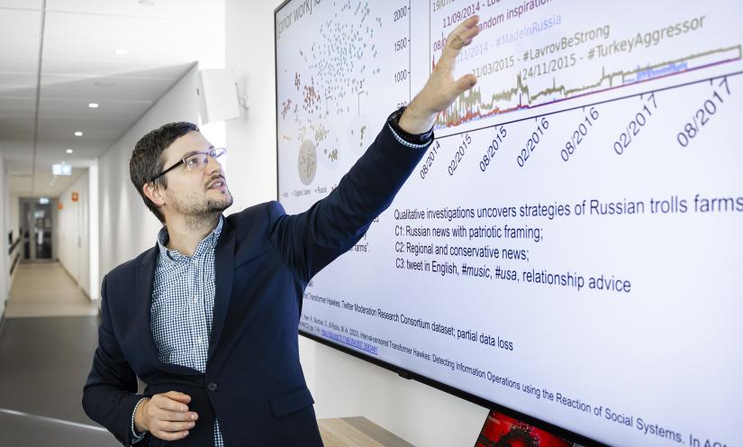 Photo of Marian-Andrei Rizoiu with whiteboard