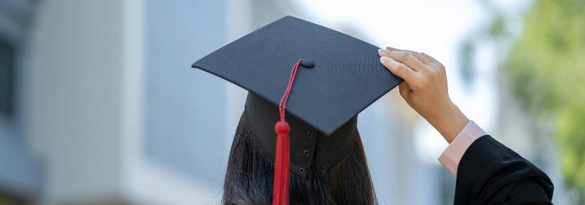 back view of a student in graduation gown and hat