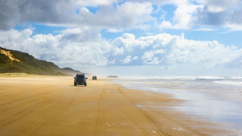 Stock picture of 4WD vehicles driving on a beach on K'Gari (Fraser Island). 