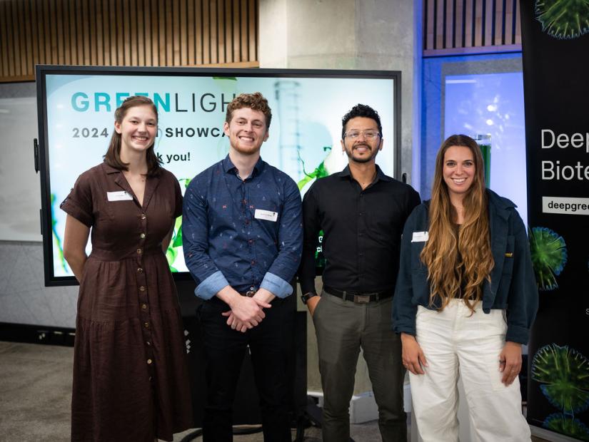 Green Light 5th Cohort standing infront of TV screen and Deep Green Biotech Hub banner