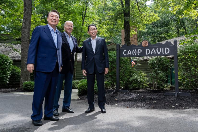 US President Joe Biden greets South Korean President Yoon Suk Yeol and Japanese Prime Minister Kishida Fumio at the trilateral summit at Camp David, Maryland, USA on August 18 2023 (Erin Scott / The White House)