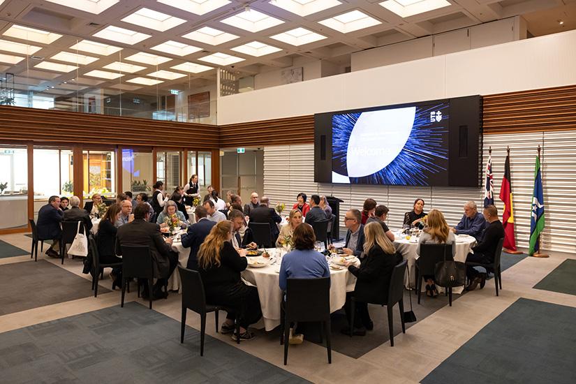 A room full of round tables in the Chancellery with alumni and UTS staff gathered to eat lunch.