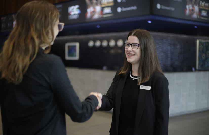 Emily Howe shaking hands with an ICC employee 