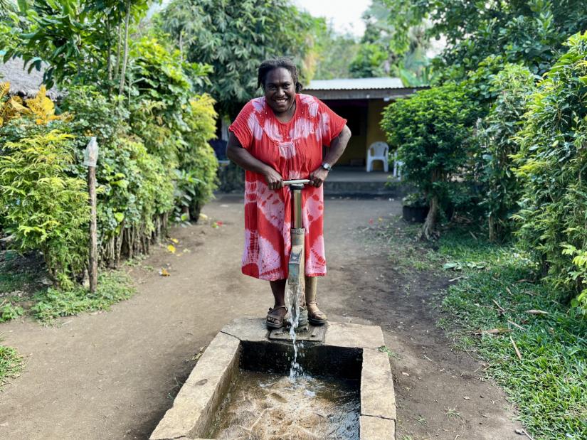 Local Fijian woman pumping groundwater.