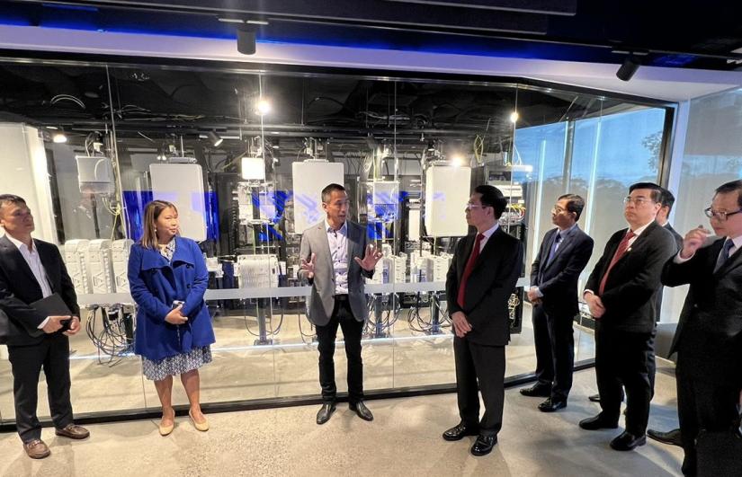 People dressed in business casual clothes standing in front of a lab.