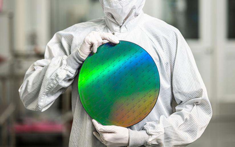 A clean room technician holding the Omega quantum photonic chipset. Picture PsiQuantum/Alex Mack 