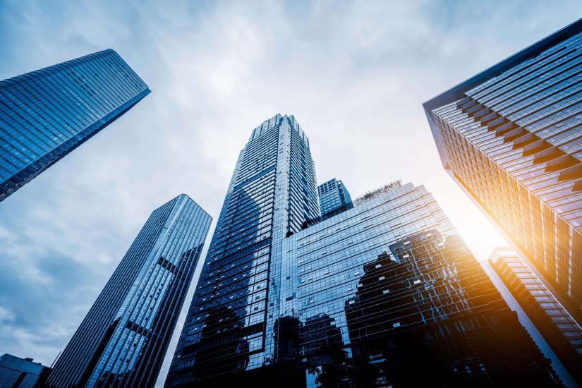 Image of tall office blocks taken from the ground looking up to the sky