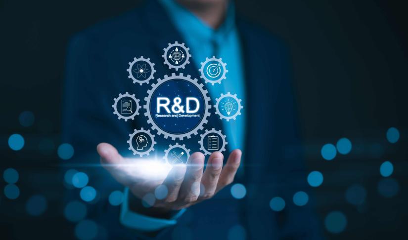 Image of a male hand holding a floating R&D icon 