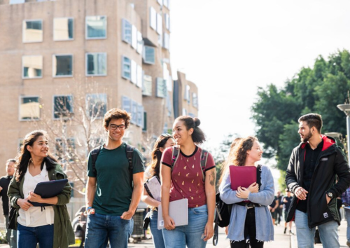 Students walking in a line near the Business Building