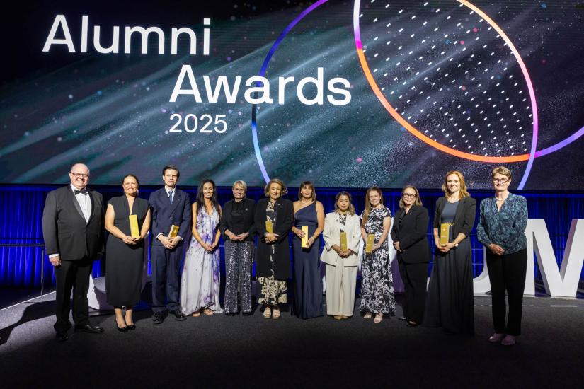 Group of Alumni Awards winners on stage with VC and Chancellor