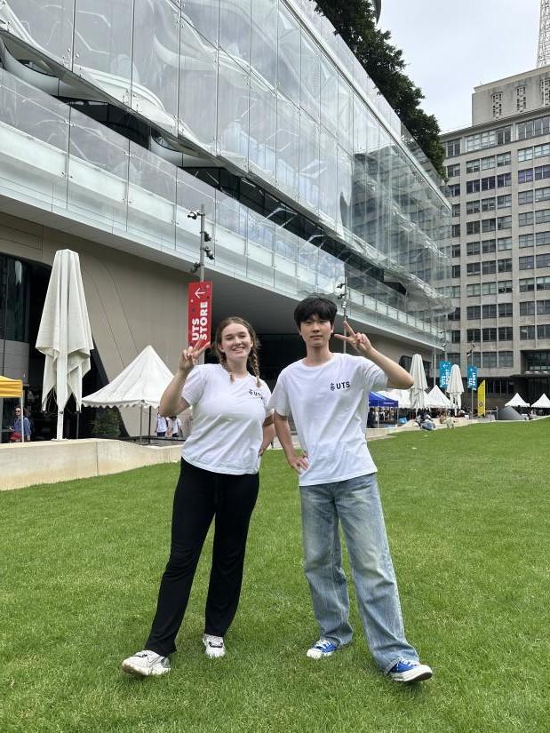 Two students in front of the UTS building