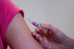 Girl receiving vaccination in her arm