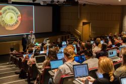 Peter Charley speaks in front of Journalism students in the Guthrie Theatre