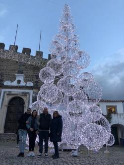 Chiara and her family next to a Christmas tree