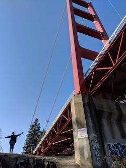 Danielle posing next to a bridge