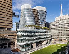 UTS Central viewed from the terrace of UTS Building 7, with a blue sky behind and its glass facade sparking in the sunlight