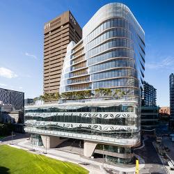 The curved lines of the glass-encased UTS Central sparkle in the sunshine, offsetting the UTS Tower next door