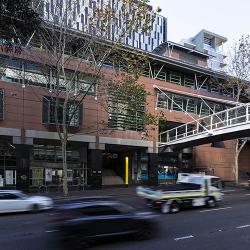 The salmon-coloured DAB building stretches along Harris St, connected by a pedestrian foot bridge over the busy road