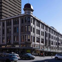 A 19th Century 4-storey building with a decorative facade and numerous tall, thin windows