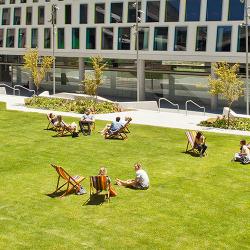 Students sitting on Alumni Green deckchairs
