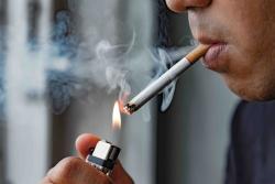 Close up of a person lighting a traditional cigarette