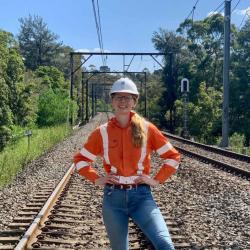 woman on train track smiling