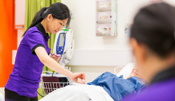 UTS Nursing student in clinical lab with patient