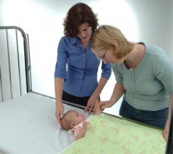 A mother and a nurse accompanying a baby