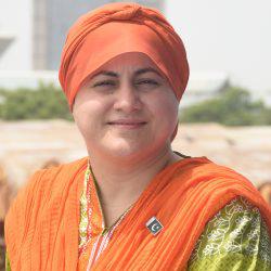 Woman looking at camera in a orange and green traditional outfit